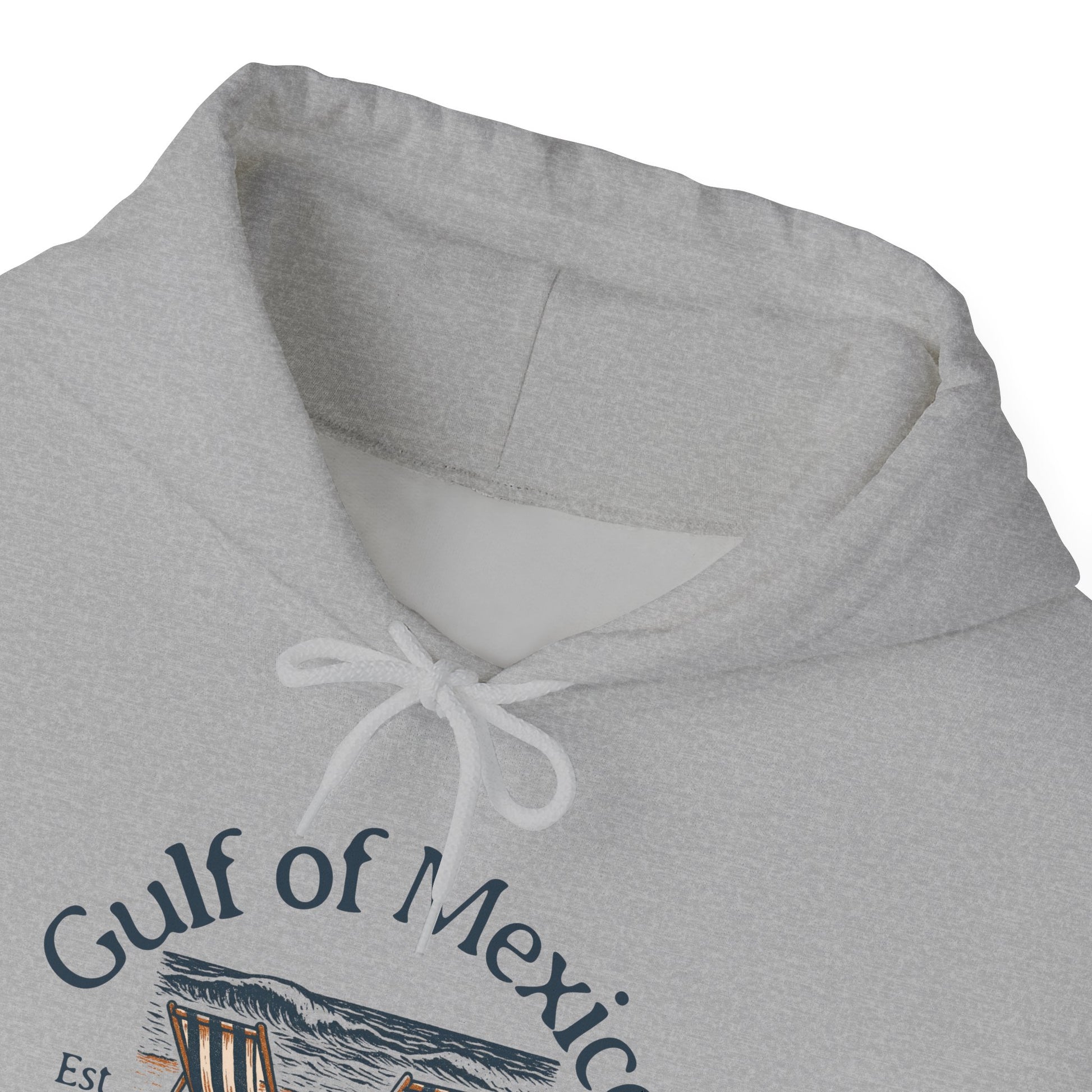 Close up of gray hoodie with 'Gulf of Mexico' text and beach graphic on a white background